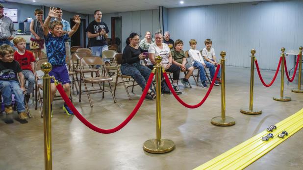 Scouts and spectators were very excited watching the derby cars race and sometimes coming out of their seats with shouts and clapping! Photo by Will Sadler