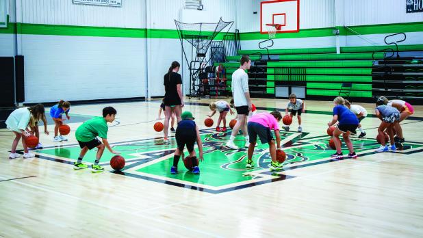 Coach Lane Dollar and Mattie Dollar run camp attendees through skill drills. Photo by Will Sadler