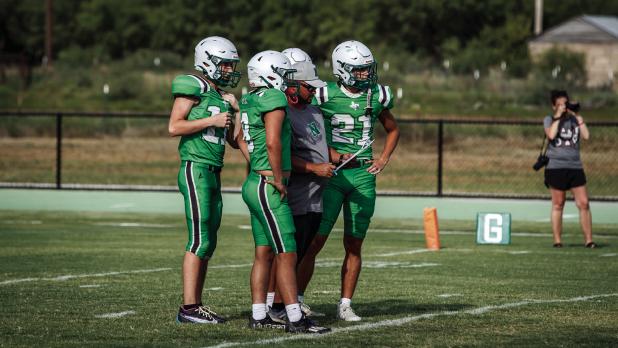 Veteran Head Football Coach Isiah Archer leads the way for another successful season for the Bobcats, shown going over a play with Bobcats during a scrimmage with St. Jo. Photo by Will Sadler