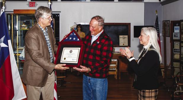 Dale Lovett receives a plaque containing a U.S. flag that flew over the U.S. Capitol in Washington D.C. from Young County Judge Win Graham and Melanie Berry, the area representaitve froom the office of U.S. Rep. Roger Williams, who procured the honor for