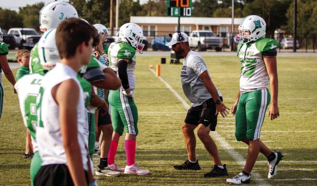 Assistant Bobcat Coach James King gives instructions and corrections to a Bobcat. Photo by Will Sadler