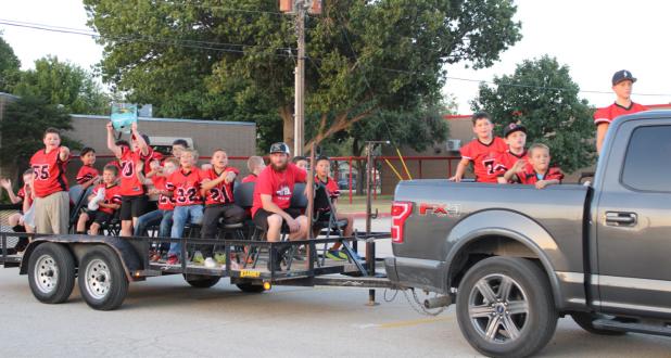 Olney Elementary School’s Top of Texas football team cheers and throws candy along the parade route, riding to Cub Stadium for a pep rally for Olney’s Homecoming game against Archer City on Sept. 16. Photo by Kailyn Altmiller