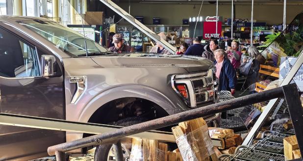 OEDC President Johnny Moore drove his truck into the front window of Stewart’s Food Store, surprising cashiers and customers last Wednesday. No one was hurt, except the plate glass window. Photo by Will Sadler