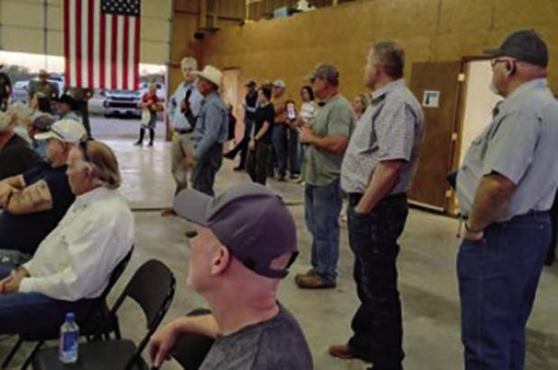 County Commissioners Jimmy Wiley and Scott Shook (standing on right) and Alan Craig and Stacy Creswell (sitting on left) listen as Young County residents question solar farm reps at the Eliasville-South Bend Volunteer Fire Department on Nov. 5. The projec