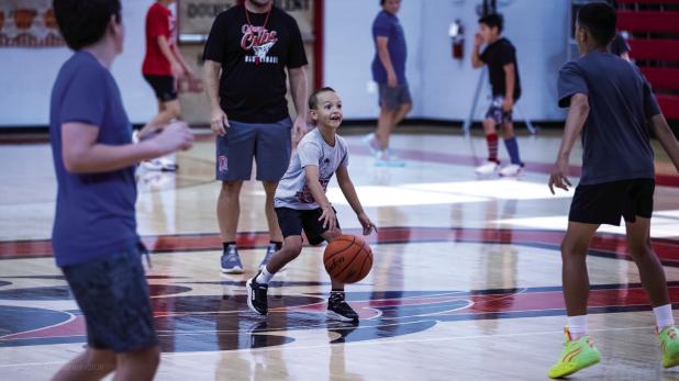 This little Cub may have been out of his league attending camp with older and bigger basketball players but there is no denying he was having the best time making memories and learning skills. Photo by Will Sadler