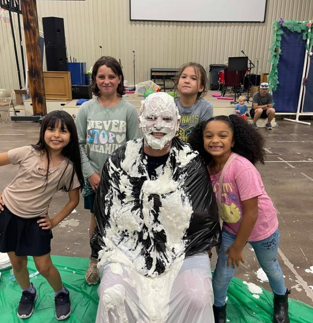 Southside Baptist Church’s Pastor Josh Hagle was “pied” by the team that raised the most for Christmas Boxes at Vacation Bible School. Clockwise from top left: Kiera Murphy, Charlotte Garcia, Zoey Manqueros and Julia. Photo provided by Southside Bap
