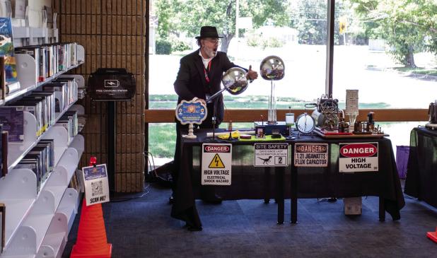 Mr. Benes demonstrates electricity before attendees of his science show at the OCLAC. Photo by Will Sadler
