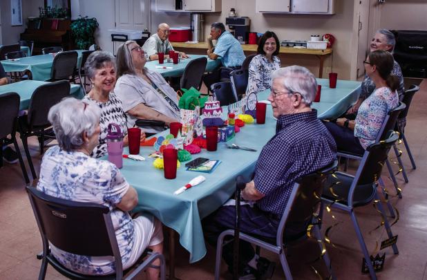 Edwana Fikes sits with her husband, Wade, at a celebration of her longtime service to the Olney Senior Cub Center on July 11. Photo by Will Sadler