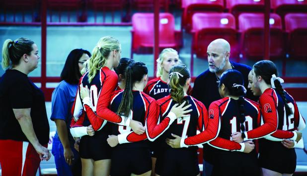 The Lady Cubs receive pregame instructions from new Volleyball Head Coach Nicholas Tarr. Look for a more in-depth look at the OHS new volleyball coach in a future issue of the Olney Enterprise. Photo by Will Sadler