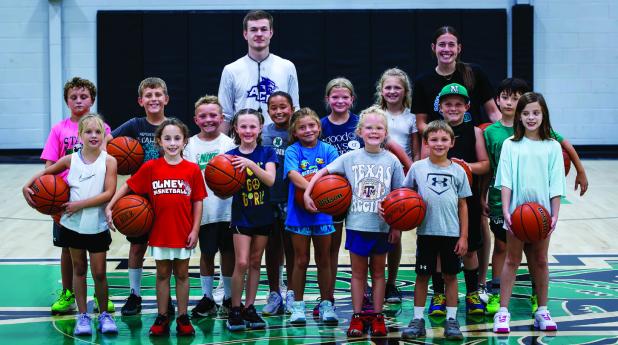 Younger Newcastle children pose with huge grins during Coach Lane Dollar’s summer basketball skills camp. The children appeared to have a great deal of fun. Photo by Will Sadler