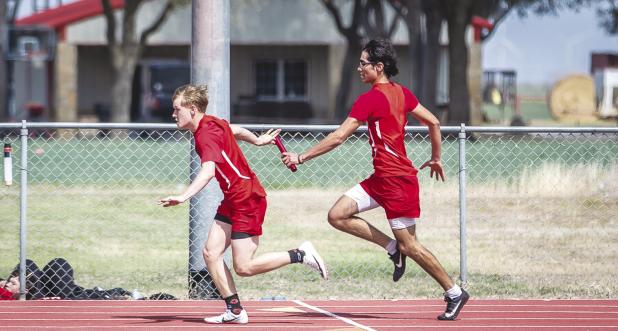 The 4x1 relay second place team consisted of Kyle Stewart, Juan Castillo, David McCarson and Domonique Collins. Shown: Juan Casteel passes the baton to OHS teammate David McCarson. Photo by Will Sadler