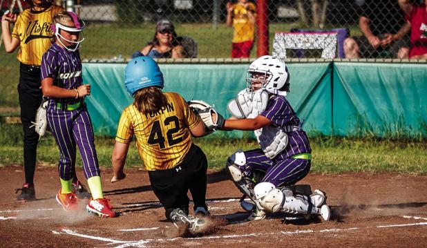 Olney Bombers were a little disappointed when the umpire called this out a safe play giving the opponent a run. Bomber was on the ball and clearly tagged the runner before the plate. You win some, you lose some calls. Photo by Will Sadler