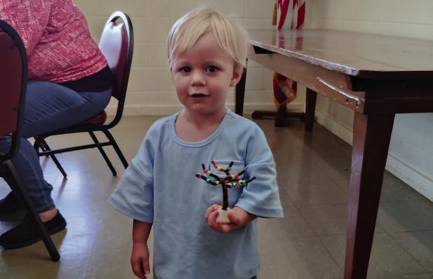Auggie Bernhardt makes at Tree of Life at St. Luke Lutheran Church’s Family Night on June 18 at the Fellowship Hall. Photo by Gina Keating