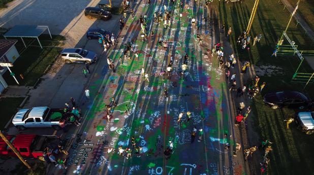 Colorful graffiti adorns Main Street Newcastle after students, athletes and the community painted messages and names to celebrate NHS HOCO week. Photo by Will Sadler