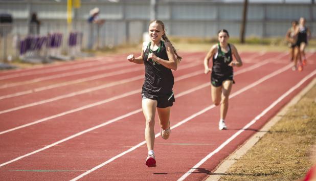NHS Ladycat Allison Melton moves on to Regionals in the 1600m and 3200m run. Photo by Will Sadler