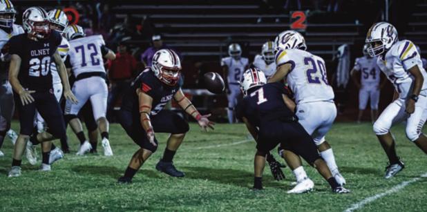 The Olney High School Cubs showed their mettle in their homecoming game at Cub Stadium on Oct. 3 with a 33-0 rout of the Crosbyton Chiefs. Here, OHS Cub Ricco Sandoval (55) showed he could run as well as guarding the quarterback and making running plays a