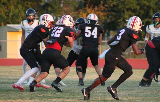 The Cubs offensive line hold off Wildcat defenders as Cubs quarterback Tucker Cortinez, #22 Kyle Stewart, and #3 Dom Collins set a play in motion at the Sept. 18 Homecoming game against Archer City. Photo by Kailyn Altmiller