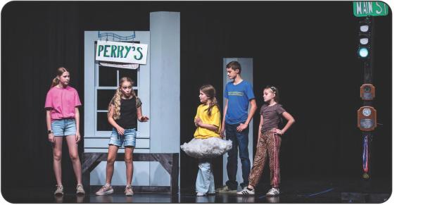 A group of teenagers hanging out on Main Street, awaiting the drag race. Photo by Will Sadler