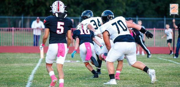 OHS Cub #10 David McCarson SSWR using his speed to run down a Bulldog ball carrier. Photo by Will Sadler