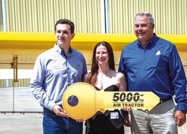 Air Tractor President Jim Hirsch (Right) hands over the key to the company’s 5,000th aircraft to Adriano and Daisy Prediger at a celebration in Olney on May 28. Photo by Will Sadler