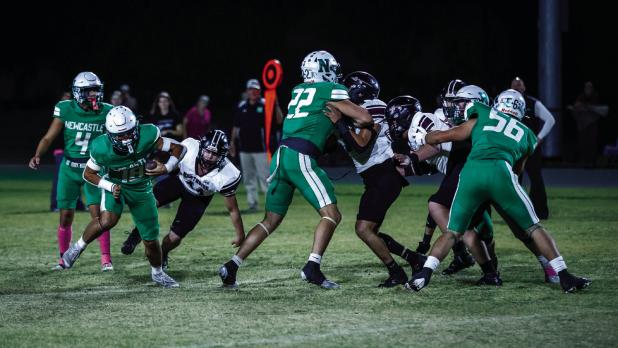 Bobcat linemen #22 Jayden Hemby and #56 Cooper Clayton bulldoze Indian defenders making way for runner #18 Keyton Newland. The Bobcat line had their way with the Indian defenders all night opening huge pathways for running drives. Photo by Will Sadler
