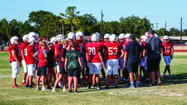 The Cubs have a team huddle after their first possession of the scrimmage with the Eagles to go over strategy for the offensive Cubs entering the field. Photo by Will Sadler
