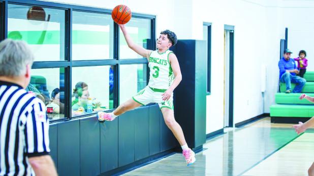 NJH Bobcat #3 Jeremy Moreno used the wall of the new NISD gym to save a ball, Moreno played an excellent defensive game for the Bobcats and gave the Longhorn shooters trouble all night. Photo by Will Sadler