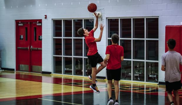 An older Cub camper goes for a lay up after travelling the length of the court at full speed. Photo by Will Sadler