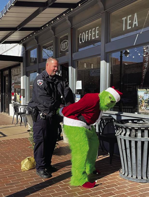 Olney Police Chief Bryan Barrett put the cuffs outside Hometown Coffee & Tea on Main Street on Dec. 22. The Grinch had been seen around town for days in multiple locations, threatening to ruin Christmas. The OPD got their man - er, Grinch -- just in t