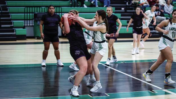 Ladycat #2 Kinsey Hawkins has that fighting Ladycat spirit needed on defense, shown fighting for control of the ball with a Lady Greyhound defender. Photo by Will Sadler