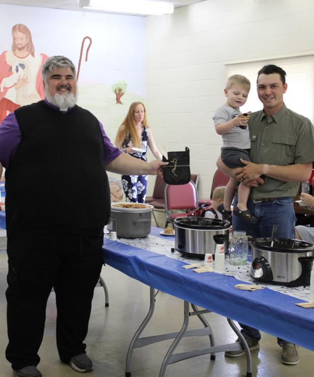 (Above) Olney Mayor Rue Rogers and his judging team award the First Place prize to Jennifer Reeves for her Yankee Chili. (Below): Pastor Sean Reeves awards the People’s Choice award to Hudson’s on Main chef Travis Hudson and his son Kohen, who won wit