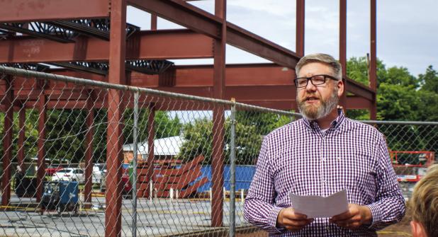 First Baptist Church of Olney Pastor Chad Edgington delivers remarks to attendees at the topping out ceremony for the church’s new $7 million education building. Photo by Gina Keating