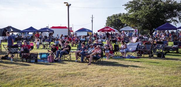 The Olney Chamber of Commerce estimated that between 1,200 and 1,300 people attended the Olney In America event at the Olney Country Club on July 2. Here, attendees listen to musicians Foster Sullivan and Daniel Latham, and headliner King George, a George