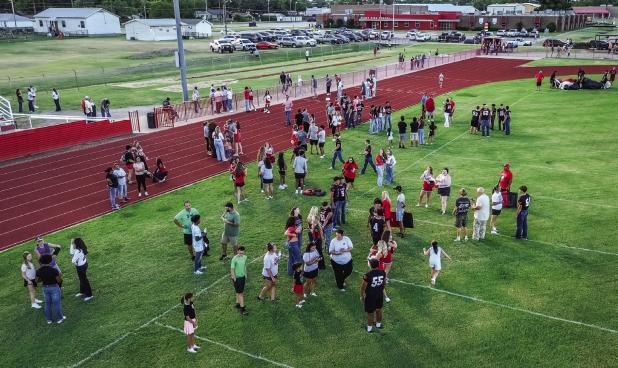 Attendees of the Olney Athletic Booster Club stuck around after the announcement of the fall athletes to socialize over watermelon and cold water. Photo by Will Sadler