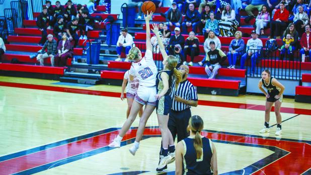 OHS Lady Cub #20 Natalie Simmons performs the tip-off and scored 7 points for the night, including a 3-point bomb from outside the line. Photo by Will Sadler