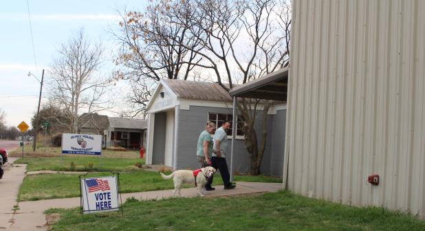 Olney City Council member Steven Nurre and his wife, Brenda, with service dog Wendy arrive at the Olney Civic Center to vote in the March 3 primary election. Photo by Gina Keating