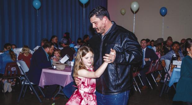 Proud fathers escorted their daughters onto the dance floor to tunes spun by DJ Rad Dad Chris Garcia to create magical memories. Olney Coach Casey Keeter dances with his daughter Addi in the pastel wonderland created by volunteers at the Olney Civic Cente