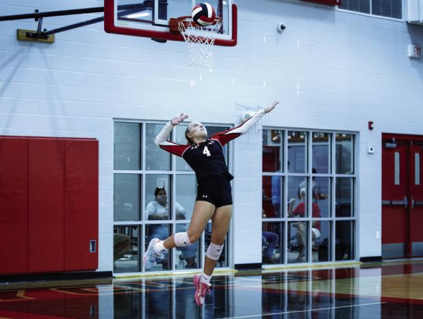 Lady Cub #4 Taylor Cadotte goes up for a powerful serve during the Lady Pirates match. | Photo by Will Sadler