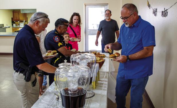 Chief Dan Birbeck speaks with peers during his going away luncheon. Photo by Will Sadler