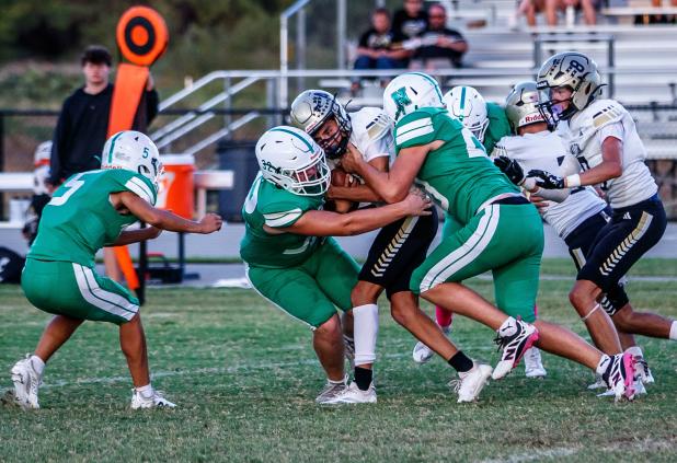 The JV Bobcats defense owned the middle for much of the game, swarming Jaybird runners. Photo by Will Sadler