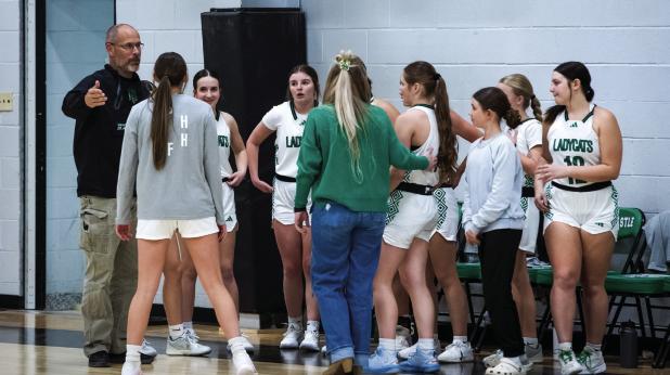 Coach Ryan Dollar addresses the Ladycats with last-minute instructions for the start of the matchup with the Lady Panthers. Photo by Will Sadler