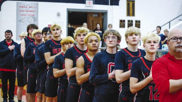 All high school varsity games start as they should - with a prayer and paying respect to the country and flag. Photo by Will Sadler
