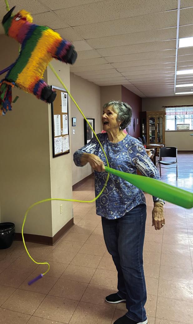 Becky Brewer takes a swing at the pinata at the Olney-Young County Senior Cub Center’s Cinco de Mayo celebration on May 5. Photo by Candy Blair