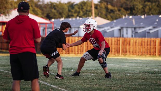 Cub defense backs practice reading quarterback calls and tackling running backs. Photo by Will Sadler