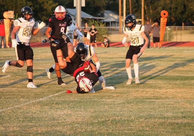 Cubs #22 Kyle Stewart is tackled by a Wildcat defender in Olney’s Sept. 18 Homecoming game against Archer City at Cub Stadium. The Cubs prevailed in the high-scoring contest, 42-36. Photo by Kailyn Altmiller