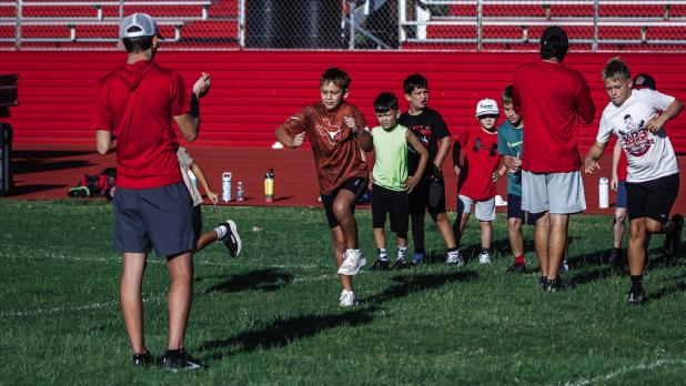Camp attendees start each day with warm-ups, which will keep injuries and muscle spasms to a minimum. Photo by Will Sadler