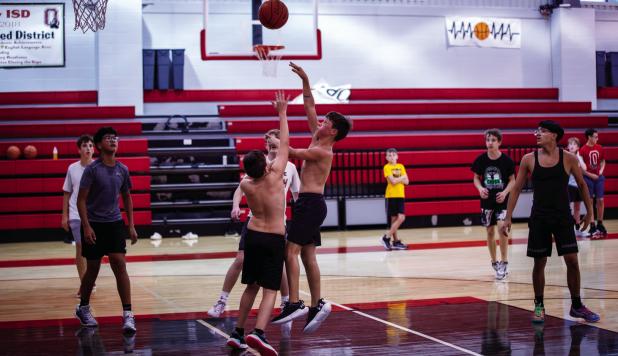 A Cub launches a floater that hits the bucket during Cub open gym night. Photo by Will Sadler