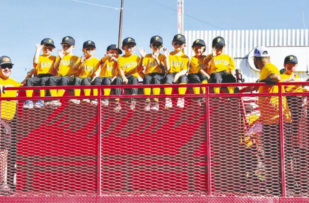 The Pirates Little League team rides high in the season-opening parade down Main Street in Olney on Saturday morning. Photo by Macy Patton