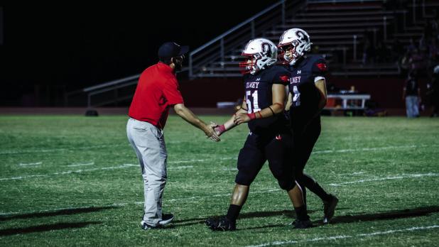 Olney Head Coach Dustin Altmiller congratulates players after the Cubs’ homecoming victory against the Crosbyton Chiefs. Photo by Will Sadler