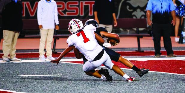 Cub #7 Damian Hernandez LB-WR sacks the Eagles QB, one of 4 sacks for the night. Hernandez had the QB scrambling all night and it was a big factor in the Cubs district win. Photo by Will Sadler